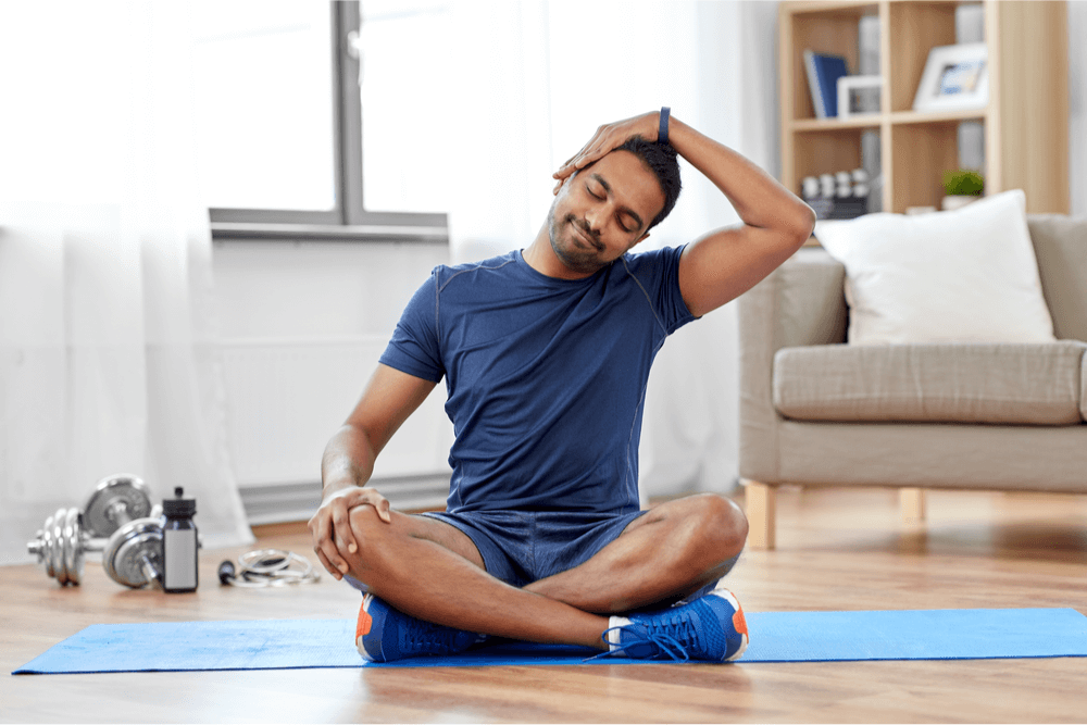 Indian man training and stretching body at home