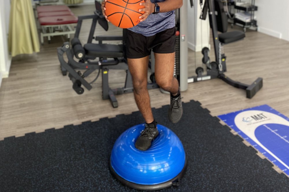 Patient balancing on a therapy ball