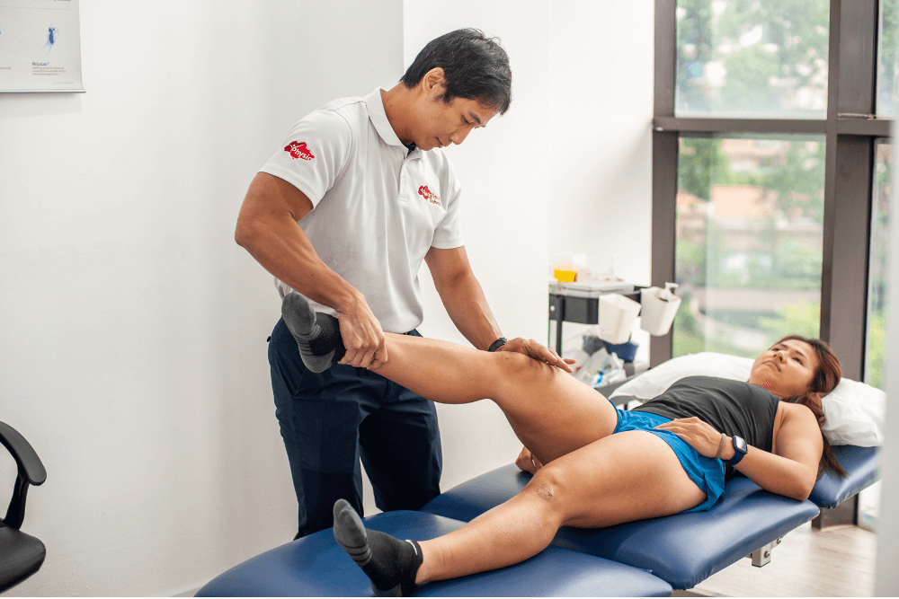 Physiotherapist applying pressure to a patient’s joints