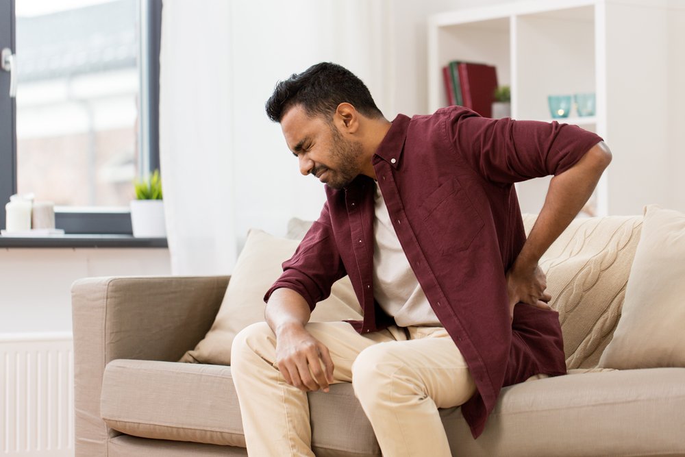 Unhappy man suffering from back pain